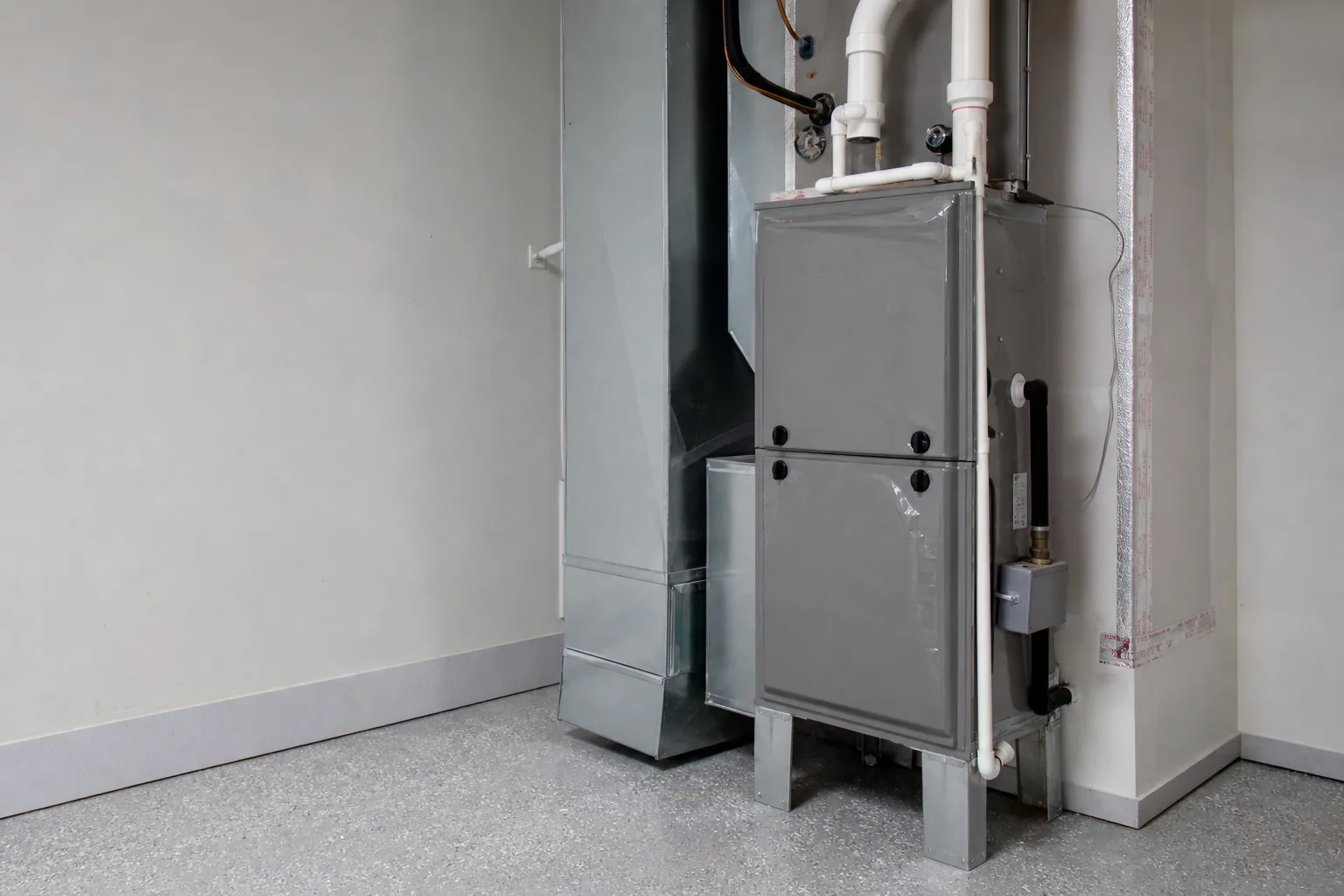 Indoor gas furnace in a Fairhope home back room, service view