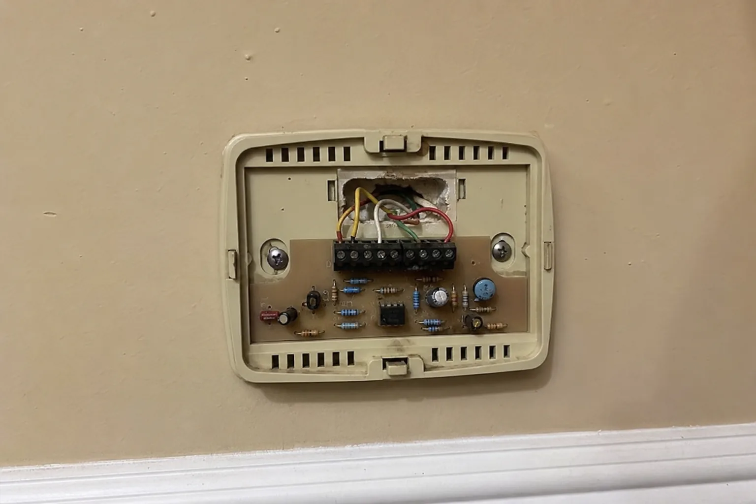 Indoor air handler being serviced in a Spanish Fort home back room, access-panel view